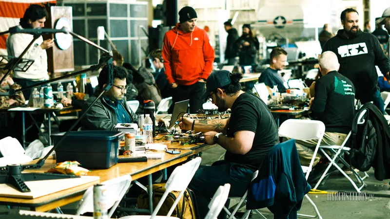 Builders working at tables aboard USS Hornet.